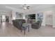 Spacious living room with wood floors, tray ceiling, neutral paint, and comfortable leather sofas at 21396 Snowy Orchid Ter, Land O Lakes, FL 34637