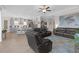 Open concept living space with wood floors, grey cabinets, and tray ceilings at 21396 Snowy Orchid Ter, Land O Lakes, FL 34637