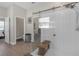 Main bathroom featuring walk-in shower, wood look floor, and walk-in closet at 21396 Snowy Orchid Ter, Land O Lakes, FL 34637
