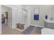 Main bathroom featuring white tile shower, wood look floor, and walk-in closet at 21396 Snowy Orchid Ter, Land O Lakes, FL 34637