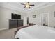 Spacious bedroom with trey ceiling, ceiling fan, television and ensuite at 21396 Snowy Orchid Ter, Land O Lakes, FL 34637