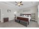 Spacious bedroom with trey ceiling, ceiling fan, carpeted floor, ensuite and sitting area at 21396 Snowy Orchid Ter, Land O Lakes, FL 34637