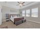 Spacious bedroom with trey ceiling, ceiling fan, carpeted floor and sitting area at 21396 Snowy Orchid Ter, Land O Lakes, FL 34637