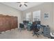Comfortable office featuring multiple monitors, natural lighting and a decorative room divider at 21396 Snowy Orchid Ter, Land O Lakes, FL 34637
