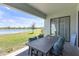 Covered patio features stylish seating and a tranquil lake view, perfect for relaxing outdoors at 21396 Snowy Orchid Ter, Land O Lakes, FL 34637