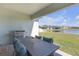 Outdoor patio with grill, table and chairs, and a view of the lake at 21396 Snowy Orchid Ter, Land O Lakes, FL 34637