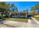 Charming single-story home featuring a cozy front porch and well-maintained front lawn at 2222 N Ridgewood Ave, Tampa, FL 33602