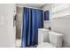 Cozy bathroom with shower-tub combo, white vanity, toilet, mirror, and blue shower curtain at 2726 25Th N Ave, St Petersburg, FL 33713