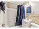 Clean bathroom with a shower-tub combo, white vanity, toilet, mirror, and blue shower curtain at 2726 25Th N Ave, St Petersburg, FL 33713