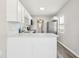 Bright kitchen featuring white cabinets, quartz countertops, stainless steel appliances, and wood-look flooring at 2726 25Th N Ave, St Petersburg, FL 33713
