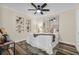 Bedroom with built-in shelves and decorations, neutral color scheme, ceiling fan, and wood-look flooring at 2734 17Th N Ave, St Petersburg, FL 33713