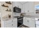 Bright kitchen with white cabinets, granite countertops, and stainless-steel appliances at 2734 17Th N Ave, St Petersburg, FL 33713