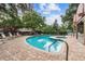 A view of a brick paved pool area that features lounge chairs, a pool and hot tub, and views of the building at 3211 W Swann Ave # 302, Tampa, FL 33609