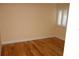 A bright bedroom featuring hardwood floors, neutral paint, and shuttered windows at 4108 Pinelake Ln # 102, Tampa, FL 33618