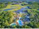 Aerial view of community with lakes, clubhouse, pool, and playground at 4127 Broad Porch Run, Land O Lakes, FL 34638