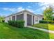 Backyard view highlighting the screened-in lanai and lush green landscaping, offering privacy and outdoor enjoyment at 4127 Broad Porch Run, Land O Lakes, FL 34638