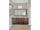 Bathroom with double vanity, granite countertop, and framed mirror at 4127 Broad Porch Run, Land O Lakes, FL 34638