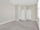 Bright bedroom boasts neutral walls, plush carpet, and white doors at 4127 Broad Porch Run, Land O Lakes, FL 34638