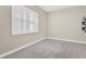 Bright bedroom features carpeted floors and natural light from the shuttered window at 4127 Broad Porch Run, Land O Lakes, FL 34638