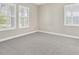 Bright bedroom with carpeted floors and shuttered windows at 4127 Broad Porch Run, Land O Lakes, FL 34638