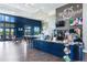 Stylish Twisted Sprocket Cafe featuring navy blue counter, coffee machines, seating, and television at 4127 Broad Porch Run, Land O Lakes, FL 34638