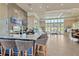 Bright cafe showcases a granite counter with barstool seating and large windows at 4127 Broad Porch Run, Land O Lakes, FL 34638
