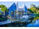 Exterior view of the community clubhouse and lakeside amenities, complete with outdoor seating, dock and lake access at 4127 Broad Porch Run, Land O Lakes, FL 34638