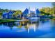 Community clubhouse overlooking a serene lake, featuring a patio deck, dock and lush natural surroundings at 4127 Broad Porch Run, Land O Lakes, FL 34638