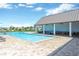 Sparkling community pool with covered seating and ping pong area at 4127 Broad Porch Run, Land O Lakes, FL 34638