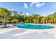 Large community pool surrounded by palm trees and lounge chairs, perfect for relaxation and recreation at 4127 Broad Porch Run, Land O Lakes, FL 34638