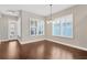 Bright dining area with hardwood flooring, shuttered windows and modern chandelier at 4127 Broad Porch Run, Land O Lakes, FL 34638