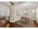 Formal dining room featuring a light fixture, neutral walls, wood floors, and a decorative area rug at 4127 Broad Porch Run, Land O Lakes, FL 34638