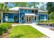 Charming fitness center boasts blue siding, white trim, and lush landscaping, inviting residents to stay active and healthy at 4127 Broad Porch Run, Land O Lakes, FL 34638