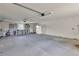 Spacious garage featuring gray epoxy flooring, overhead lighting, built-in cabinets, and ample room for parking and storage at 4127 Broad Porch Run, Land O Lakes, FL 34638