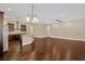 Open-concept living area with hardwood floors that connect the kitchen and living spaces at 4127 Broad Porch Run, Land O Lakes, FL 34638