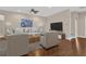 Well lit living room with modern decor, comfortable seating, and hardwood flooring at 4127 Broad Porch Run, Land O Lakes, FL 34638
