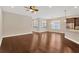 Spacious living area with ceiling fan, plantation shutters, and hardwood flooring at 4127 Broad Porch Run, Land O Lakes, FL 34638