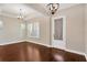 Bright living room with hardwood floors, plantation shutters, and stylish ceiling fixtures at 4127 Broad Porch Run, Land O Lakes, FL 34638