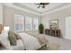 Bright main bedroom with plenty of natural light from three large windows and a decorative dresser at 4127 Broad Porch Run, Land O Lakes, FL 34638