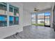 Enclosed patio with ceiling fans and tile flooring, overlooking the backyard at 4127 Broad Porch Run, Land O Lakes, FL 34638