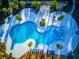 Aerial view of a unique, modern pool area with ample seating and sunbathing space at 4127 Broad Porch Run, Land O Lakes, FL 34638