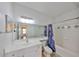 Clean bathroom featuring a shower/tub combo, a large mirror, and vanity with ample counter space at 4207 S Dale Mabry Hwy # 2412, Tampa, FL 33611