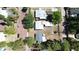 High-angle aerial view shows residential neighborhood with mature trees, neighboring homes, and paved road in clear weather at 4218 2Nd S Ave, St Petersburg, FL 33711