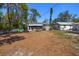 View of the backyard with picnic table, storage shed, kayaks and a partially-screened enclosure on a sunny day at 4218 2Nd S Ave, St Petersburg, FL 33711