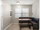 Cozy dining room with a built-in booth and natural light from the large window at 4218 2Nd S Ave, St Petersburg, FL 33711