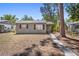 Charming single-story home with a stone walkway, natural shutters, and mature trees at 4218 2Nd S Ave, St Petersburg, FL 33711