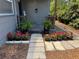 Charming front porch with ferns and bright red flowers creates a welcoming entrance to the home at 4218 2Nd S Ave, St Petersburg, FL 33711