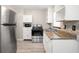 Clean kitchen featuring stainless steel appliances, granite countertops, and white cabinets at 4218 2Nd S Ave, St Petersburg, FL 33711