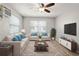 Comfortable living room with neutral sofa, stylish rug, and flat screen TV at 4218 2Nd S Ave, St Petersburg, FL 33711