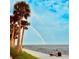 A scenic waterfront view showing a double rainbow, palm trees, a promenade, and clear blue skies on a beautiful day at 4218 2Nd S Ave, St Petersburg, FL 33711